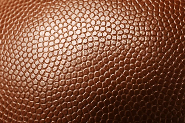 Leather American football ball as background, closeup