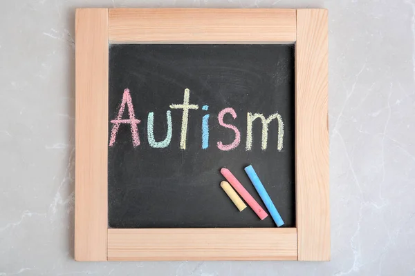 Chalkboard with word AUTISM on light background
