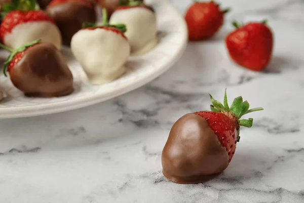 Delicious chocolate covered strawberry on table, closeup