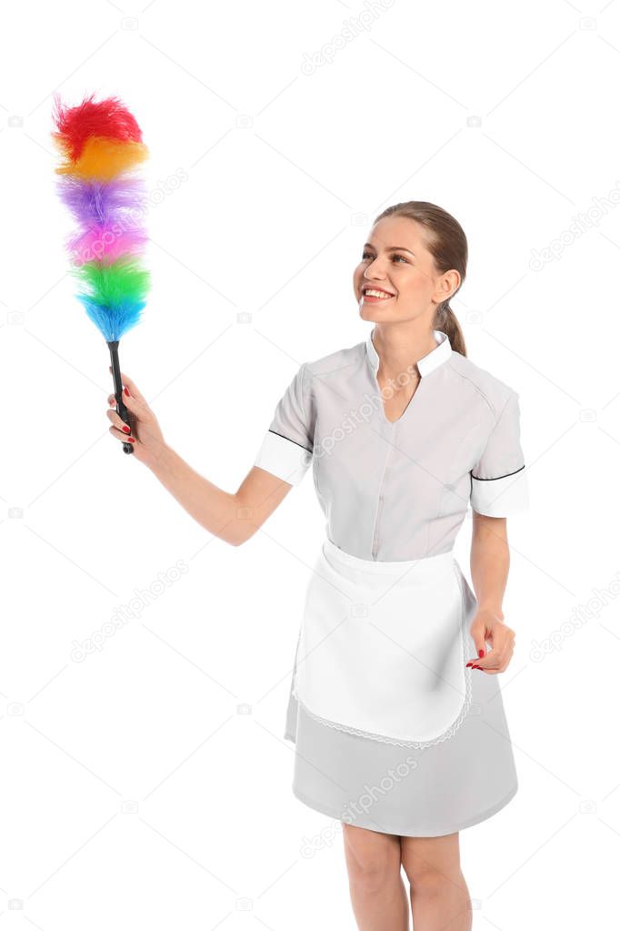 Young chambermaid with dusting brush on white background