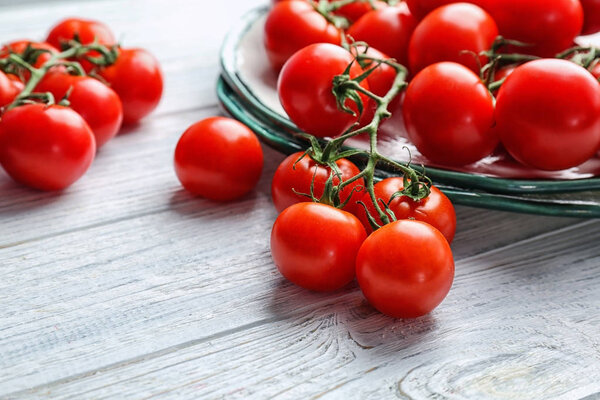 Fresh ripe red tomatoes on wooden table