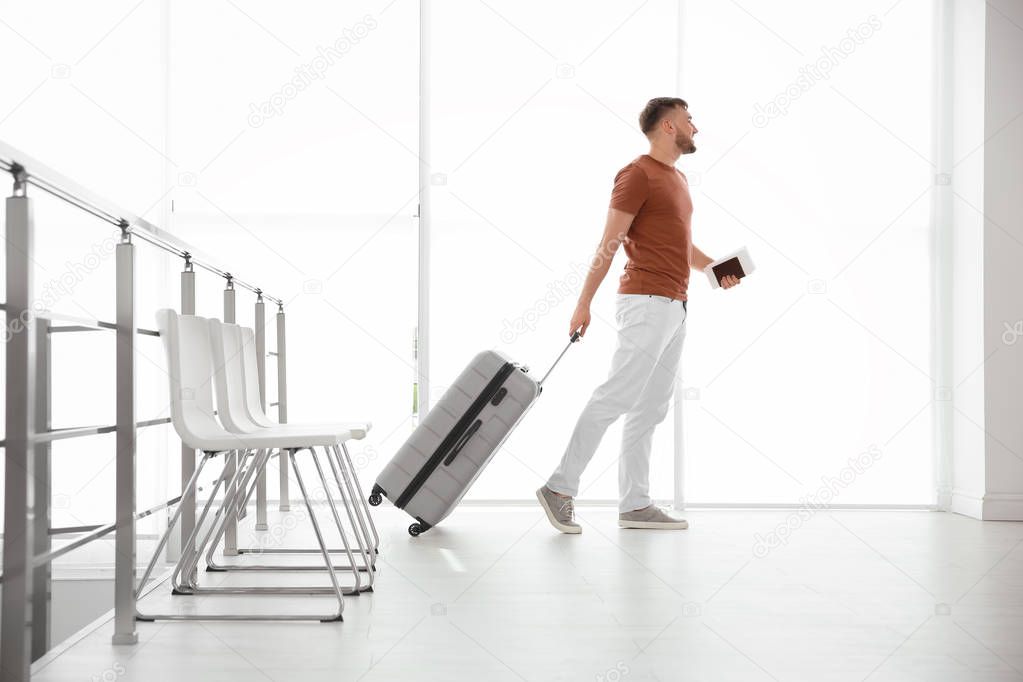 Young man with suitcase in airport