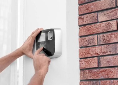 Genç erkek teknisyen alarm sistemi kapalı programlama