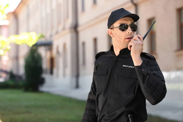 Male Security Guard Using Portable Radio Transmitter Outdoors — Stock Photo, Image