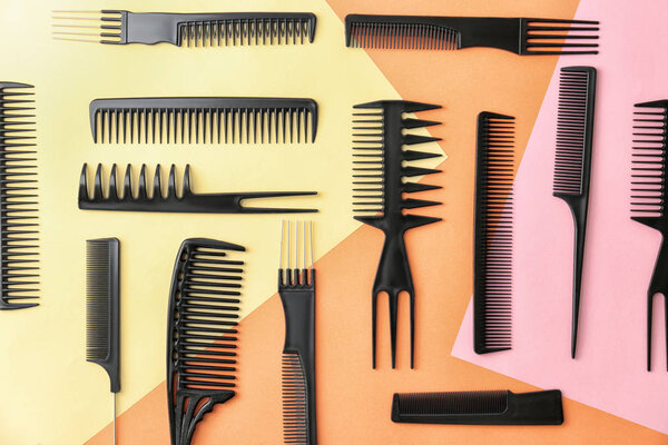 Flat lay composition with professional hairdresser tools on color background