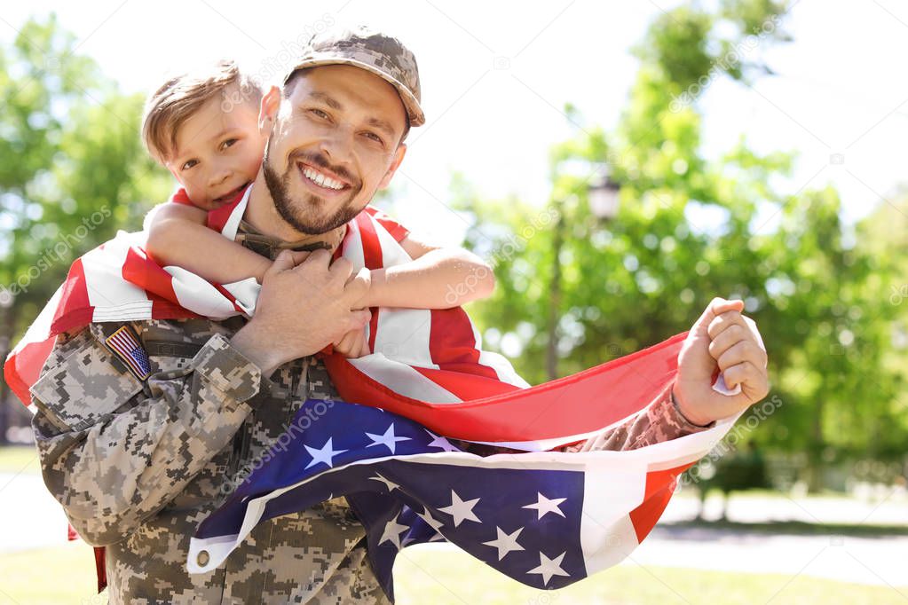 American soldier with his son outdoors. Military service