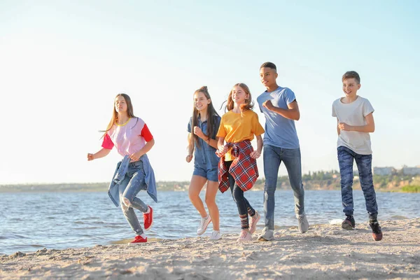 Group of children running on beach. Summer camp