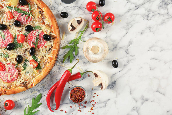 Composition with delicious pizza and ingredients on marble background, top view