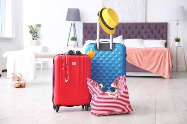 Large suitcases and bag packed for summer journey in room