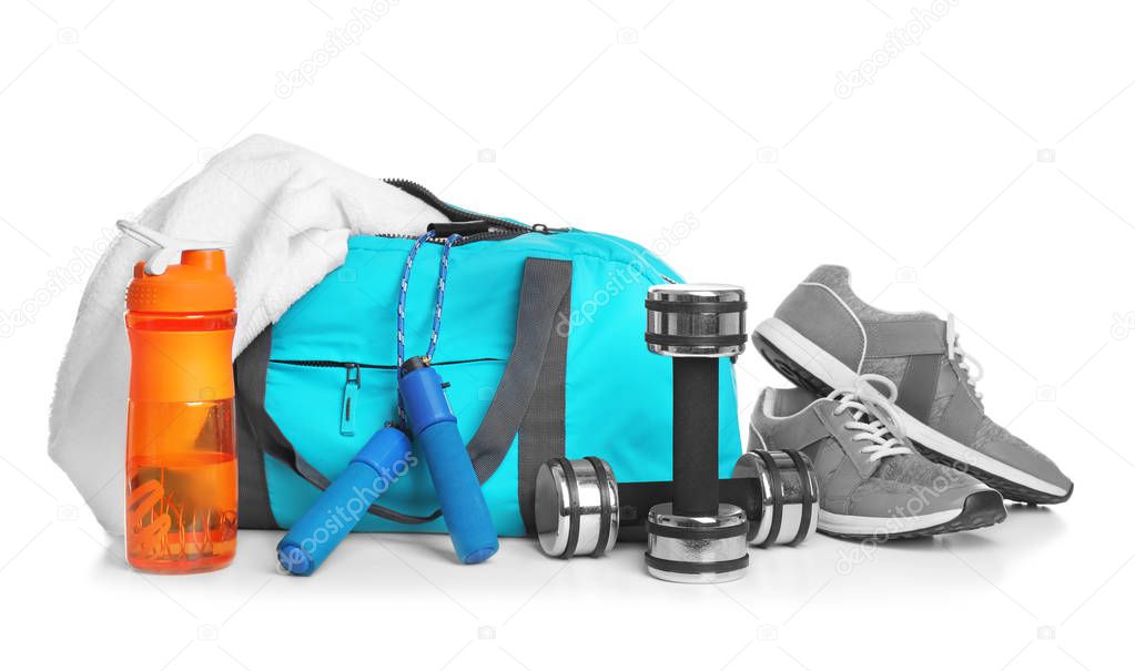 Sports bag and gym stuff on white background