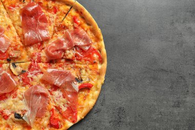 Gri zemin üzerine pastırma ile lezzetli pizza