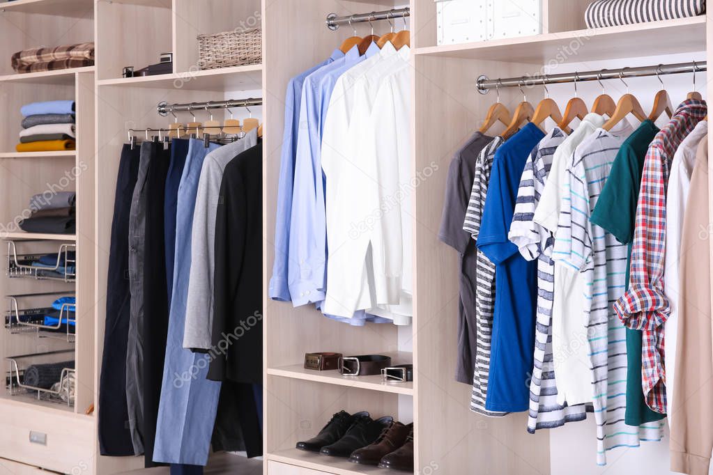 Large wardrobe with different clothes and shoes