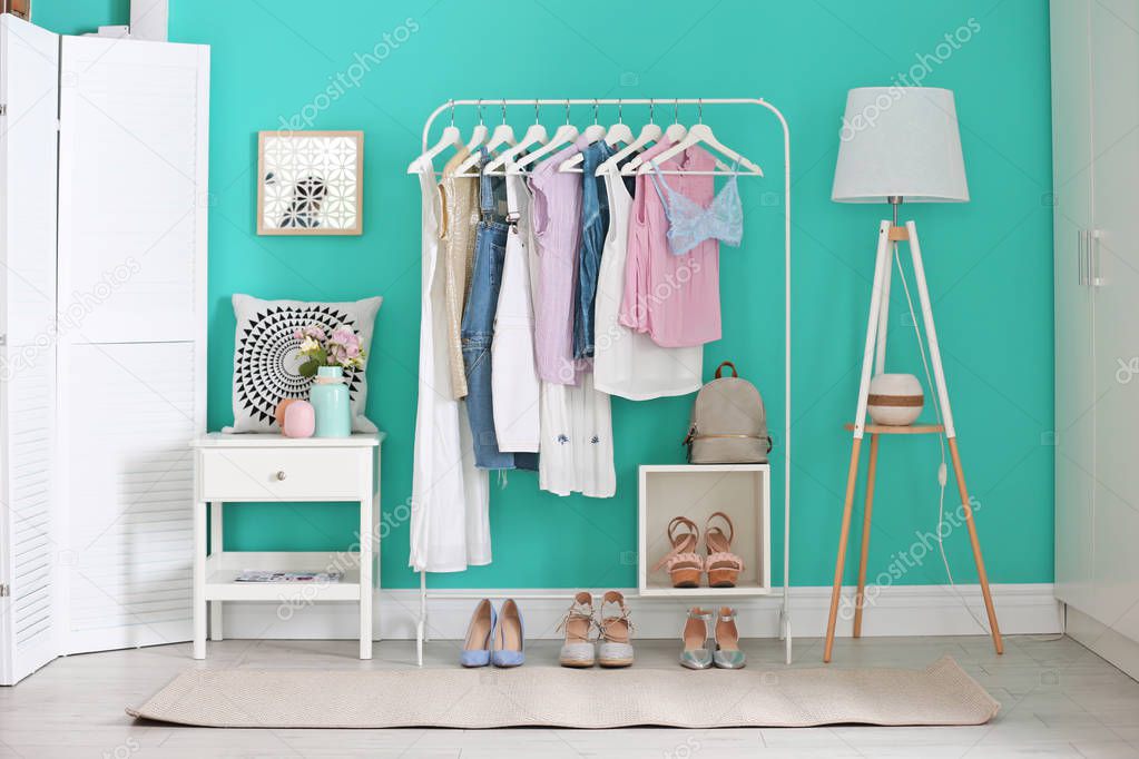 Stylish dressing room interior with clothes rack