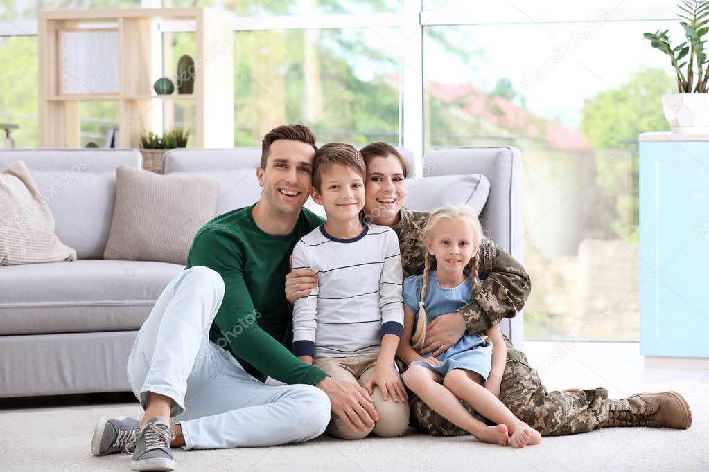 Woman in military uniform with her family at home