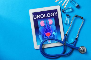 Flat lay composition with tablet and stethoscope on color background. Urology concept clipart