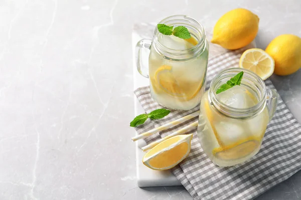 Mason jars of natural lemonade on table