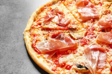 Gri zemin üzerine pastırma ile lezzetli pizza