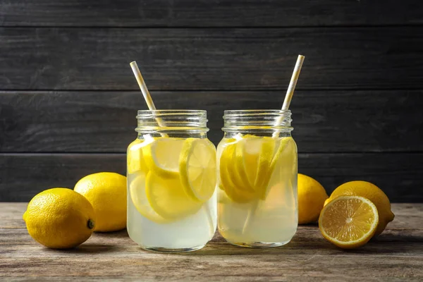 Natural lemonade in mason jars on wooden table
