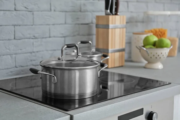 Saucepan on electric stove in modern kitchen