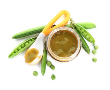 Jar with healthy baby food and green peas on white background, top view clipart