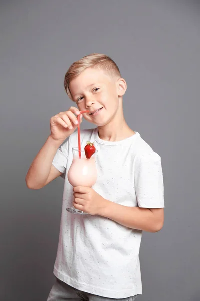 Liten Pojke Med Glas Milkshake Grå Bakgrund — Stockfoto