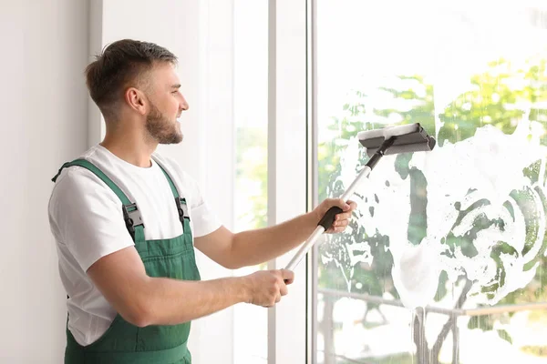 Male Cleaner Wiping Window Glass Squeegee Indoors — Stock Photo, Image