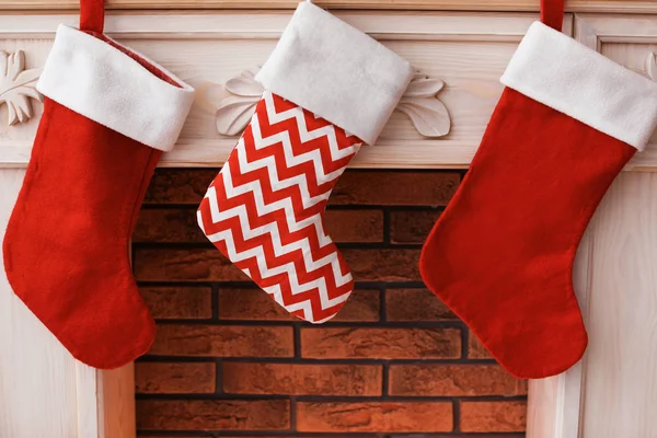 Decorative fireplace with red Christmas stockings indoors