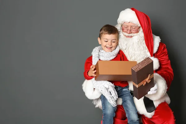Chlapeček Dárkový Box Sedí Klíně Autentické Santa Claus Šedé Pozadí — Stock fotografie