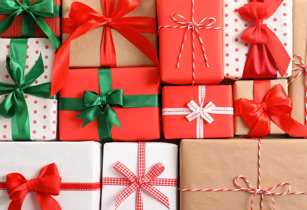 Beautifully wrapped gift boxes as background, closeup