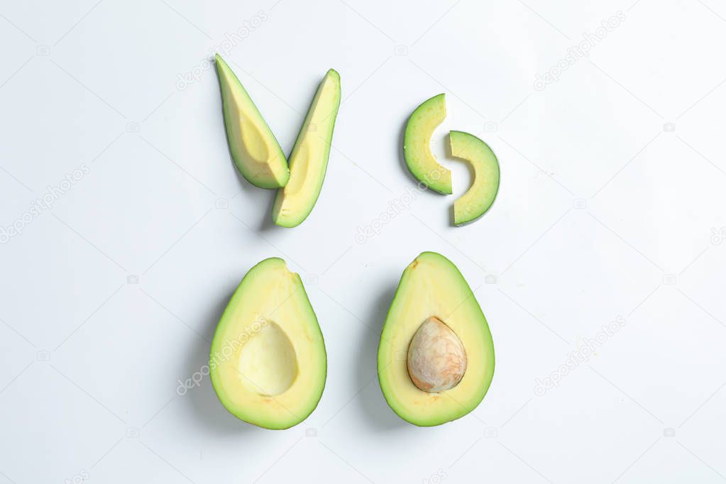 Composition with ripe fresh avocados on white background