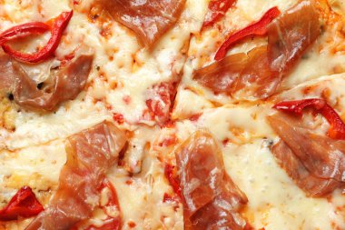 Arka plan, closeup olarak etli lezzetli sıcak pizza