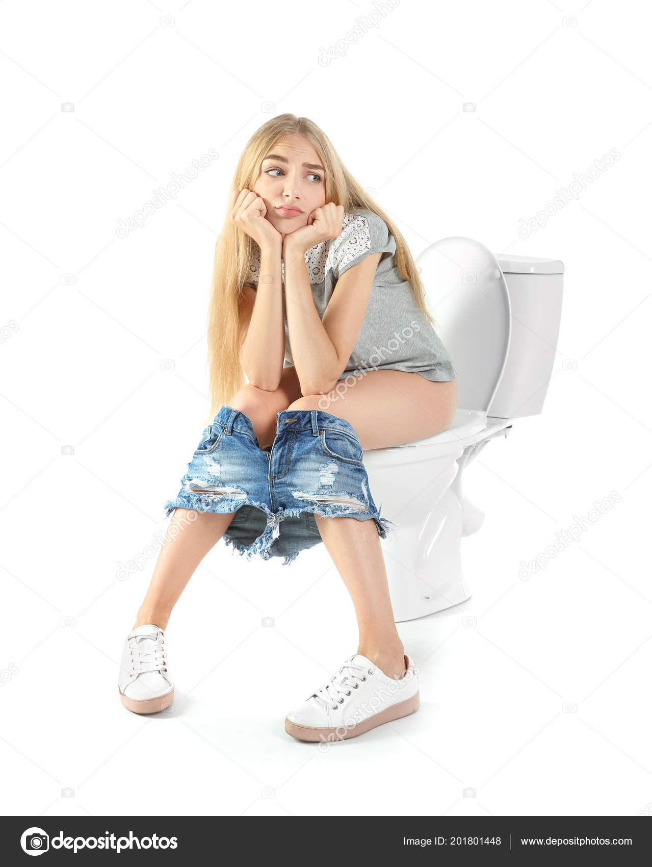 Young Woman Sitting On Toilet Lid Stock Photo | Getty Images