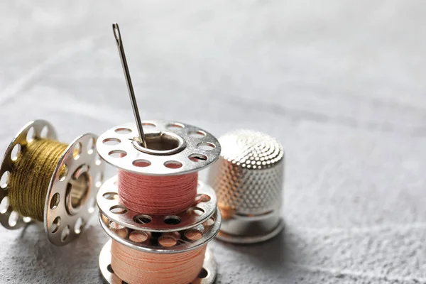 Set of tailoring accessories on grey background, closeup