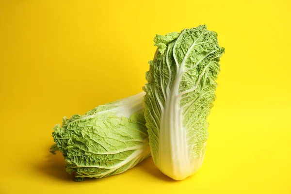 Fresh ripe cabbages on color background
