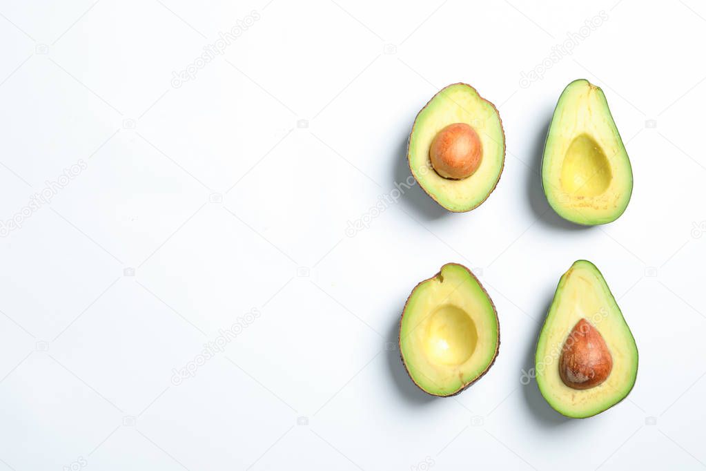 Composition with ripe fresh avocados on white background