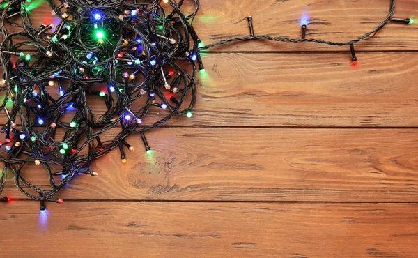 Glowing Christmas Lights Wooden Background Top View — Stock Photo, Image