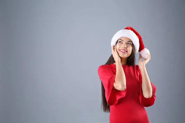 Młoda Piękna Kobieta Santa Hat Szarym Tle Boże Narodzenie Celebracja — Zdjęcie stockowe