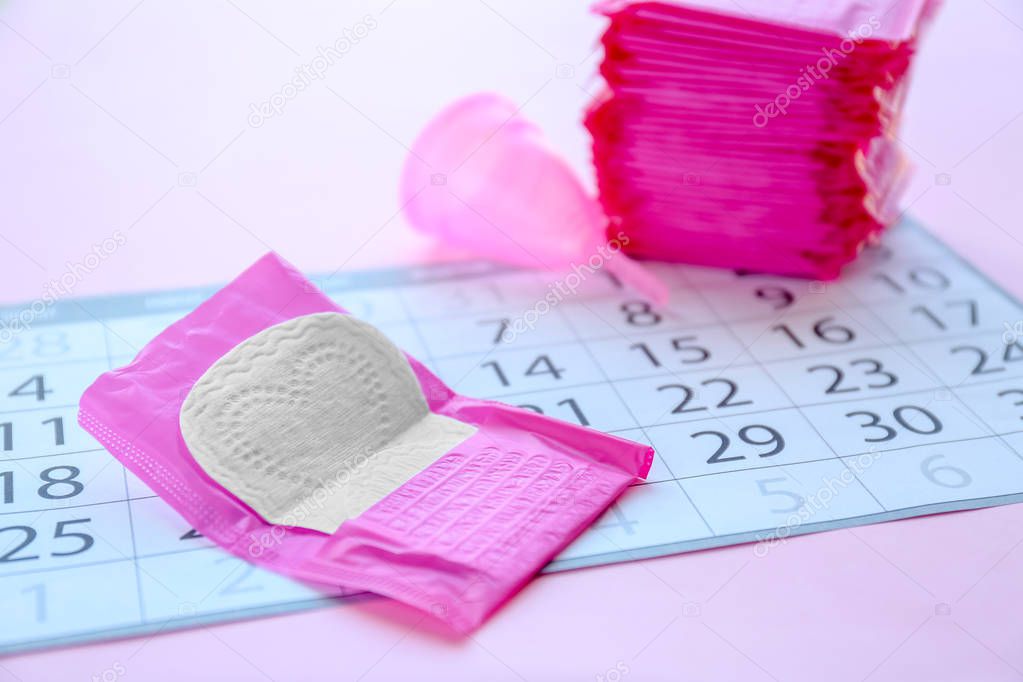 Menstrual pad and calendar on table. Gynecological care