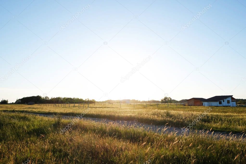 Picturesque view of countryside with houses in field