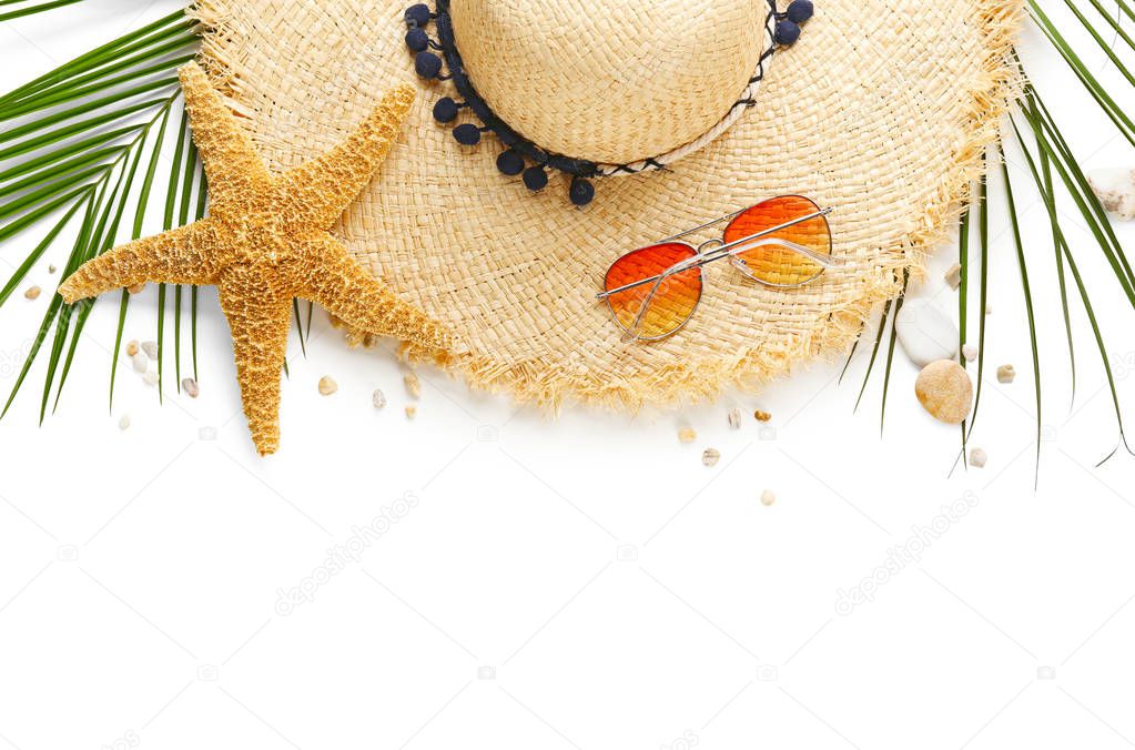 Flat lay composition with stylish hat and beach objects on white background