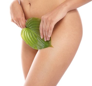 Pürüzsüz bir cilt sonra bikini epilasyon beyaz arka plan üzerinde gösterilen yaprak olan kadın