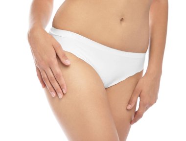 Beyaz arka plan üzerinde bikini epilasyon sonra pürüzsüz cilt gösteren genç kadın