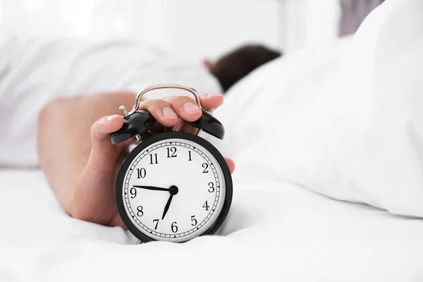 Man Turning Alarm Clock Bedroom — Stock Photo, Image