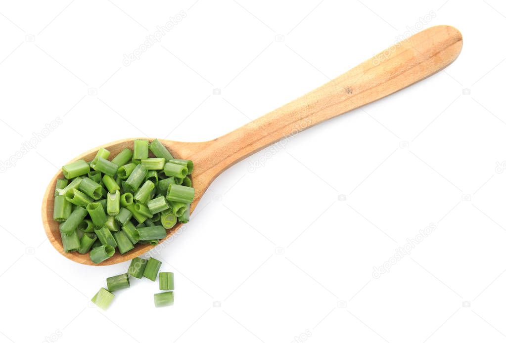 Spoon with chopped green onion on white background, top view