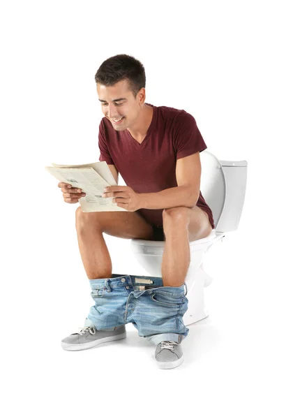 Jonge Man Lezing Krant Zittend Pot Geïsoleerd Wit — Stockfoto