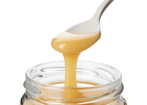 Honig Tropft Vom Löffel Das Glas Auf Weißem Hintergrund — Stockfoto
