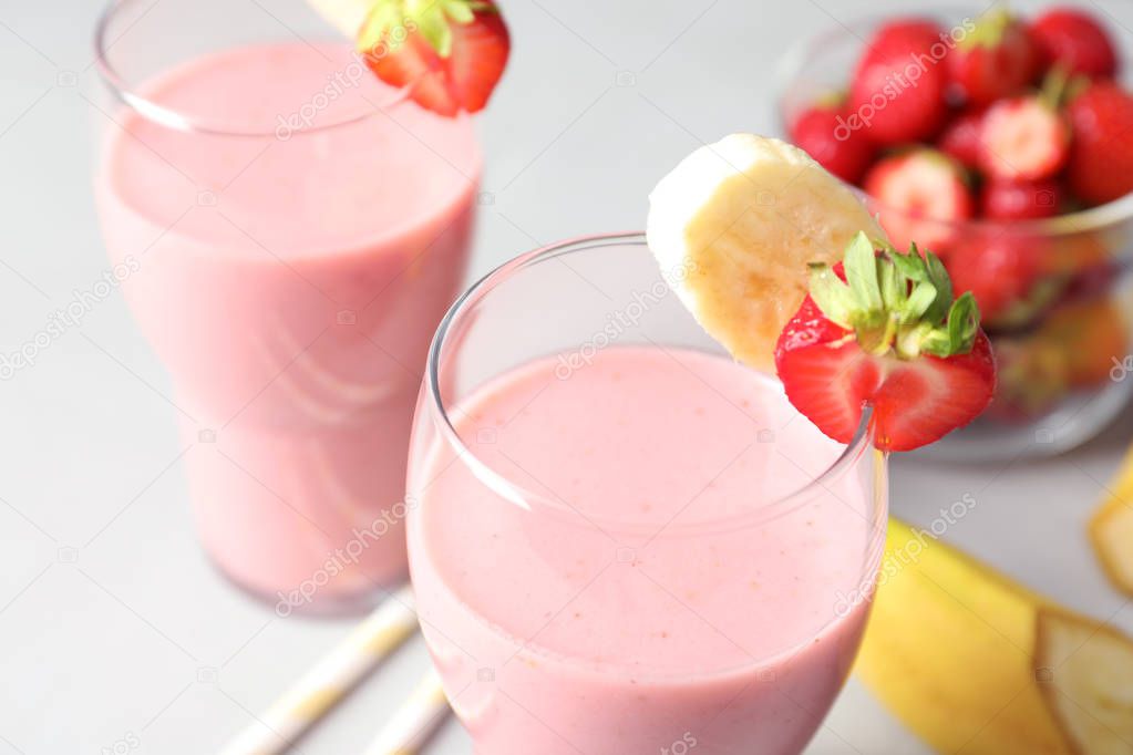 Glasses with tasty strawberry smoothie, closeup