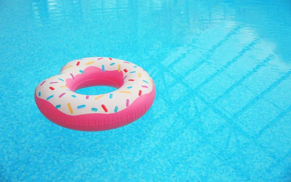 Inflatable ring floating on water in swimming pool