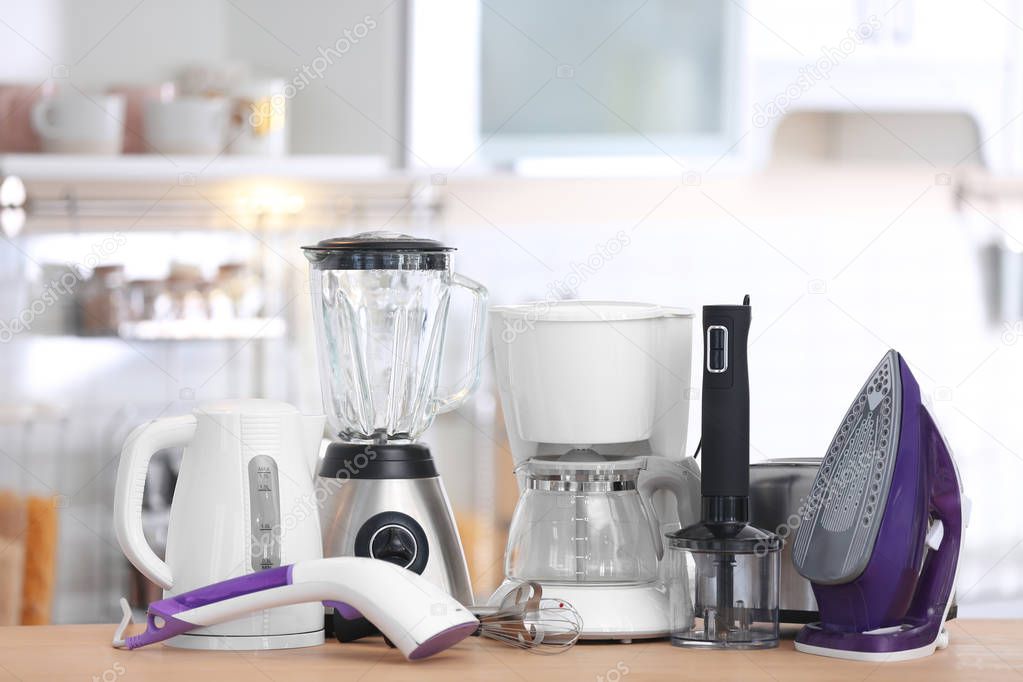 Household and kitchen appliances on table indoors. Interior element