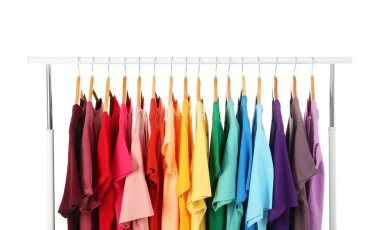 Birçok t-shirt sipariş gökkuşağı renkleri beyaz arka plan üzerinde asılı